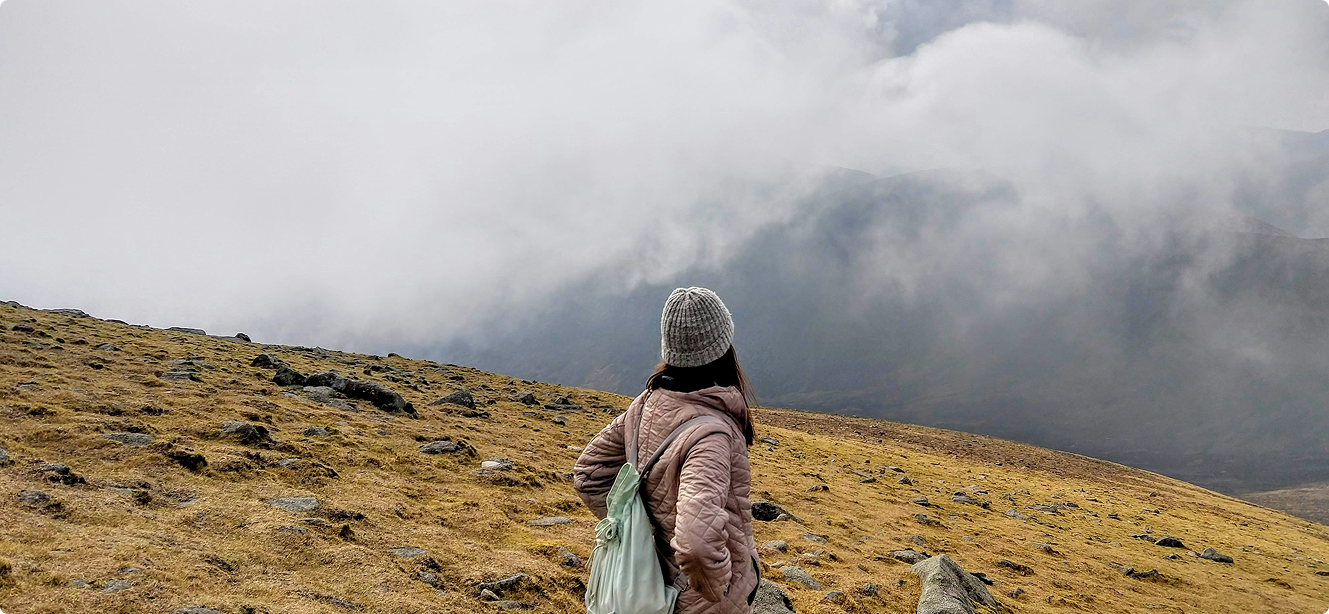 Person looking at misty mountain