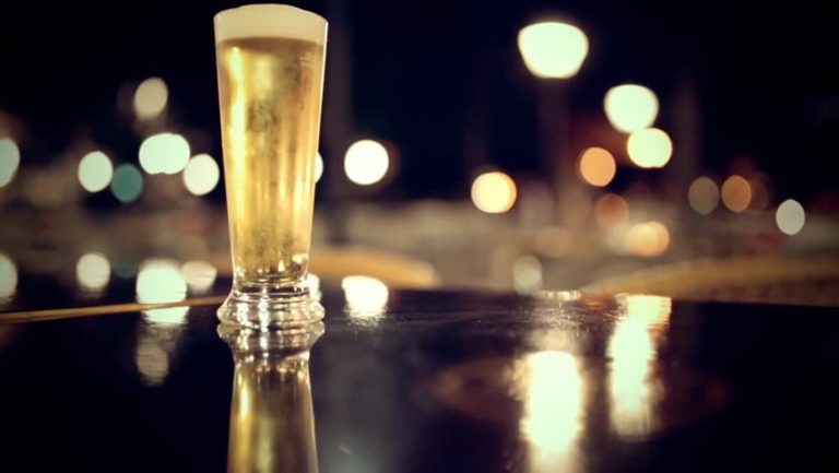 Glass of Beer on Table at Night