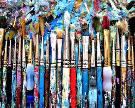 Dirty Paintbrushes in a Line on Canvas