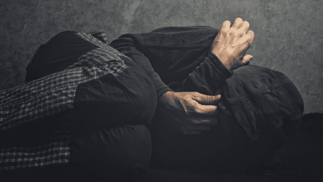 Legal Intoxicants and Legal Dissociatives Depressed Man Laying Sideways with Head in Knees