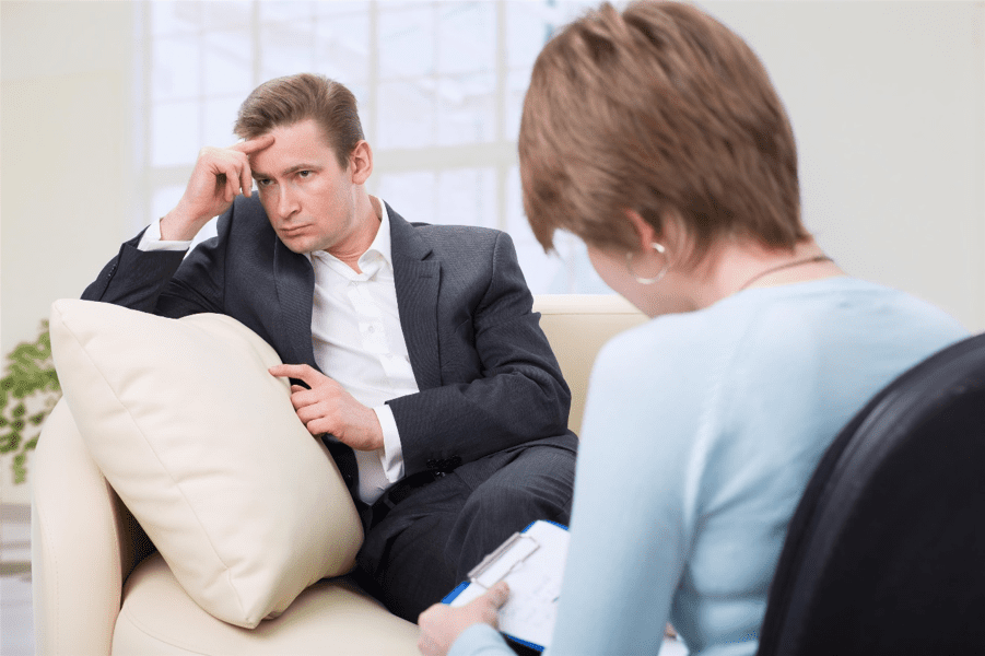 Patient Sitting on Couch Meeting with Doctor