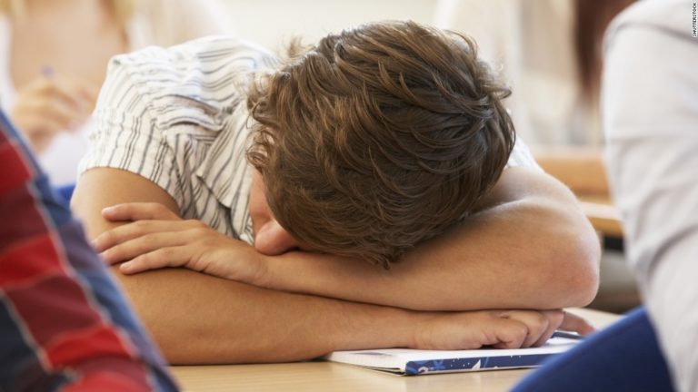 tired teen with head down