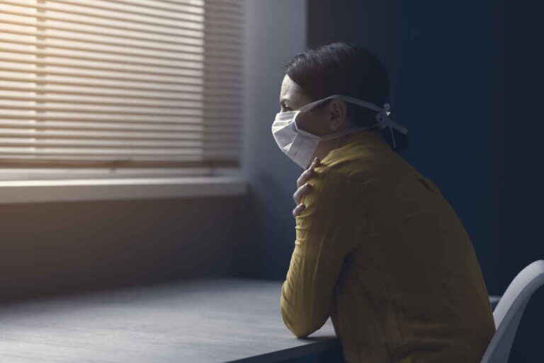 Quarantined woman with covid-19 wearing a face mask