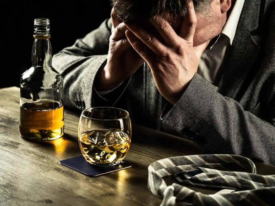 Stressed out businessman drinking whiskey